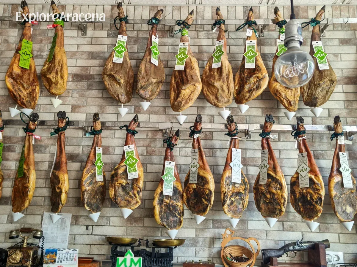 hanging-cured-hams-brick-wall-in-aracena